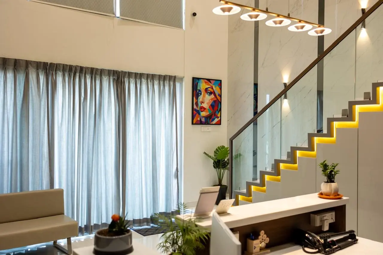 Double height reception with lit staircase